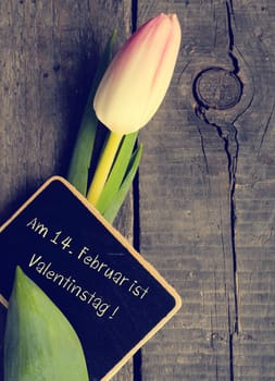 Tulip with a small blackboard, German Valentines Day concept background, vintage color stylized