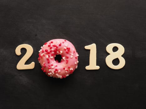 Sweet pink donut with the number 2018, sweet New Year concept