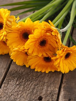 Bunch of yellow daisies on rustic wood, spring time or Valentines Day concept background