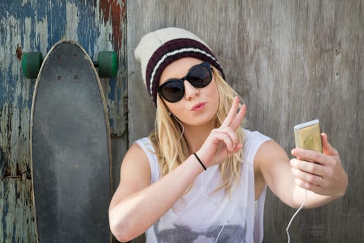 Cool skater girl taking selfie
