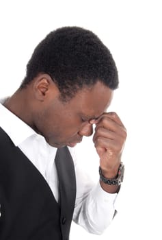 A close up of a frustrated young African American man looking down.with his hand on his forehead, isolated for white background.