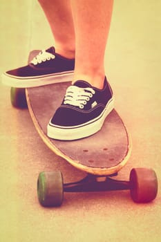 Girl riding skateboard with vintage filter
