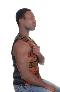 A tall handsome African American man sitting with his fist on his.chest, without shirt, isolated for white background.