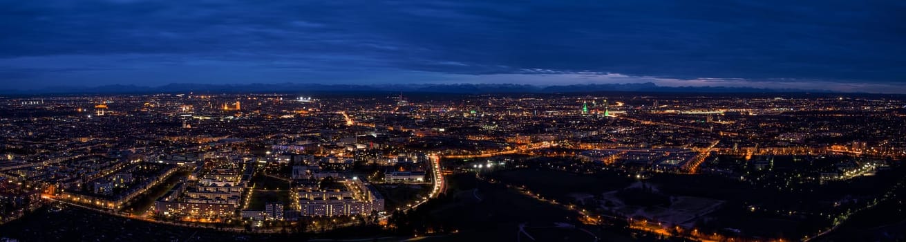 Munich center cityscape night panoramic aerial view. Skyline panorama captured from height of lookout viewing platform on tv-tower.