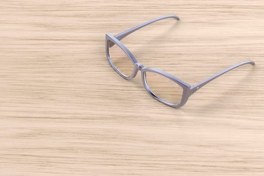 Female eyeglasses on wooden table