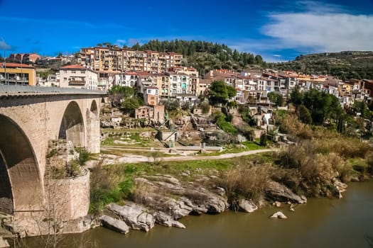 Arched bridge leading to small town in northern Spain