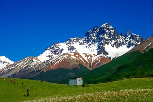 Small hut at the foot of the Mount Cerro Castillo as seen from Carretera Austral road, Patagonia,  southern Chile