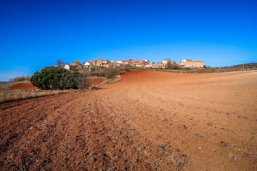 Small Spanish village and a field in an early spring