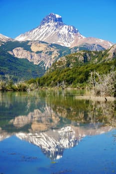 Lake reflection of mount Cerro Castillo as seen from Carretera Austral road in Patagonia, southern Chile