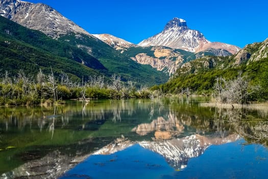 Lake reflection of mount Cerro Castillo as seen from Carretera Austral road in Patagonia, southern Chile