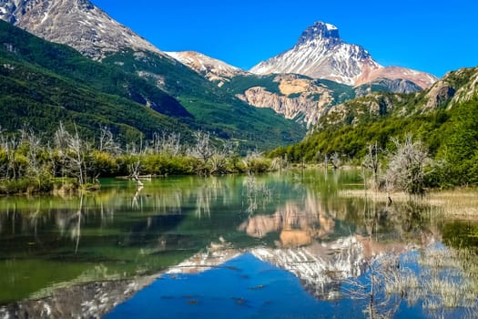 Lake reflection of mount Cerro Castillo as seen from Carretera Austral road in Patagonia, southern Chile