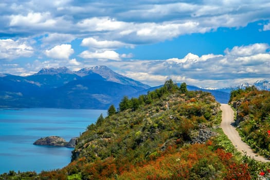 Gravel road called Carretera Austral passing along the shore of a beautiful lake General Carrera in the reomte part of southern Patagonia, Chile