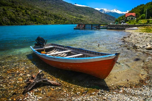 Small boat on the riverbank in Patagonian Andes, Chile