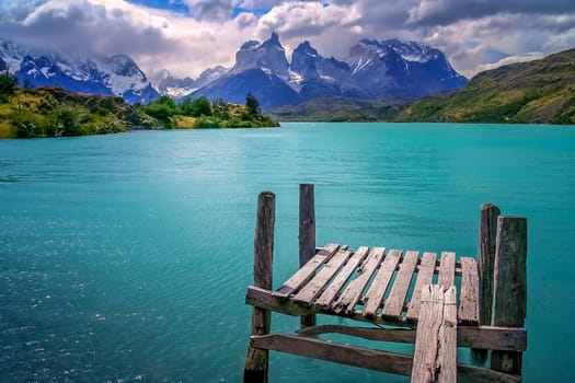 Wooden platform on a lake with a view of Cuernos del Paine, Patagonia, Chile