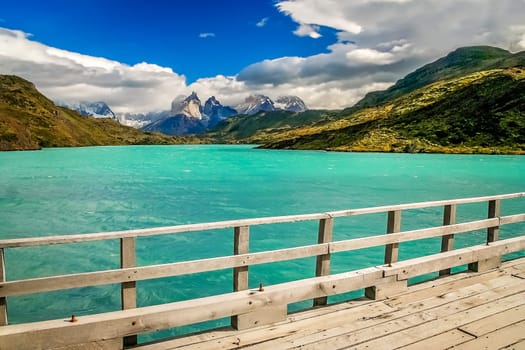 Wooden bridge over the river with a view of Cuernos del Paine, Patagonia, Chile