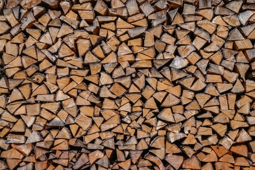 Firewood logs stacked in piles outside cottage