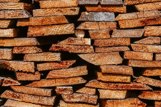 Firewood logs stacked in piles outside cottage