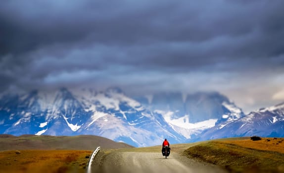 Girl cycling in Torres del Paine National Park, Chile, South America