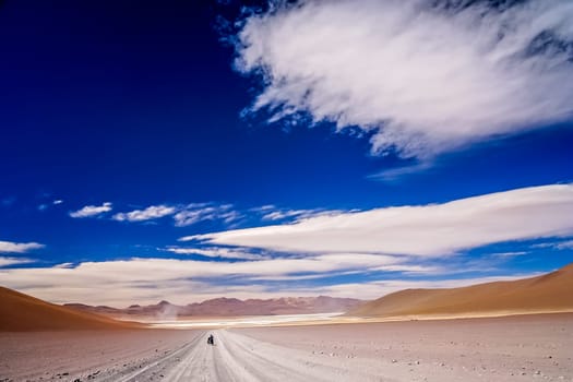 Lonely cyclist travelling through remote part of southern Altiplano, Bolivia