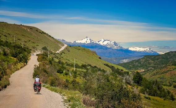 Cyclist climbing up the hill on the Carretera Austral, southern Patagonia, Chile
