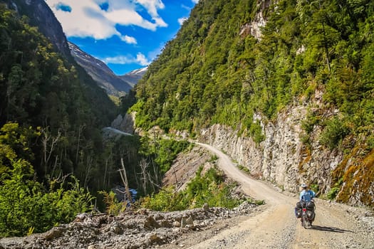 Cyclist climbing up the hill on the Carretera Austral, southern Patagonia, Chile