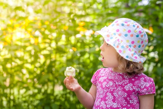 Cute little girl eating freshly picked apple