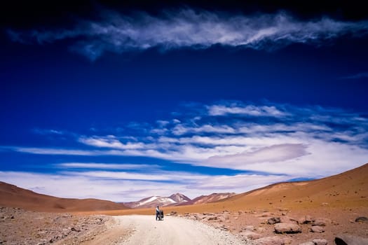 Lonely cyclist travelling through remote part of southern Altiplano, Bolivia