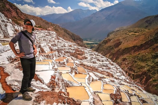 Tourists admiring the traditional salt mine  salinas  in Maras, Peru, South America