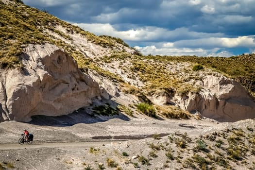Woman cycling on the famous national Ruta 40 quarenta in the remote part of central Argentina