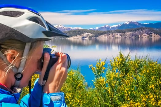Female cyclists taking pictures  of the stunning landscape of the beautiful lakes in Lake District near Bariloche, Argentina