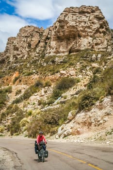 Woman cycling on the famous national Ruta 40 quarenta in the remote part of central Argentina