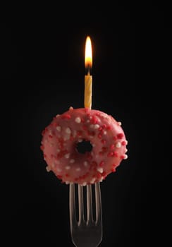 Birthday candle on a donut, puristic birthday background