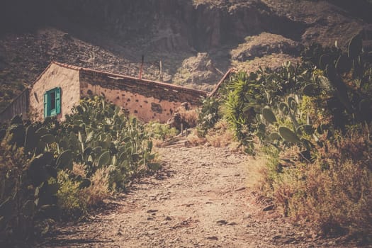 Gravel road leading to a small village home ( looking abandoned ) in Gran Canaria, Spain