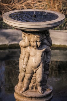 Small fountain in the Rookery in Streatham Common Park in London, UK