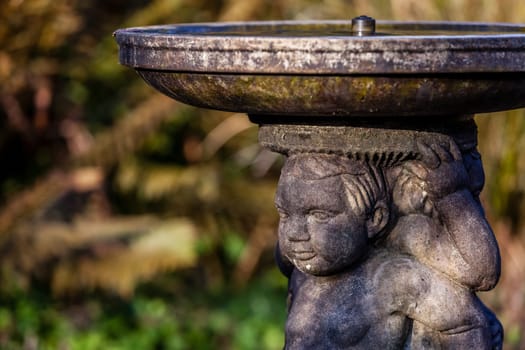 Close up of a detail of a small fountain in the Rookery in Streatham Common Park in London, UK