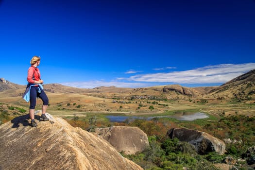 Woman admiring the view from the rocky edge in Anja Reserve in Madagascar
