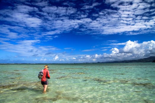 Girl walking between two Nosy Antafa islands during low tide
