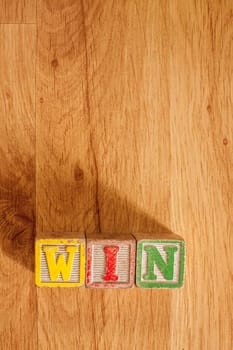 Vintage Wooden Childrens Blocks spell out the word Win