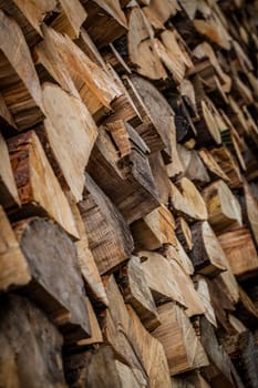 Firewood stacked in piles outside cottage in Germany