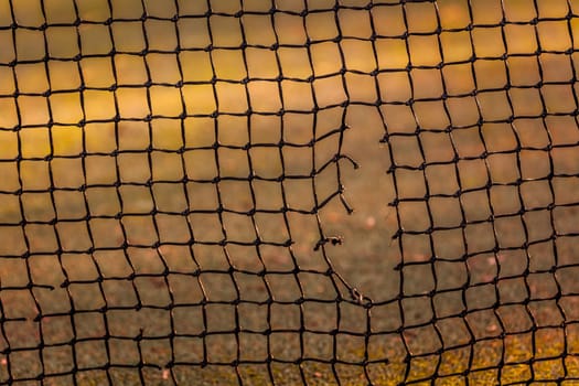 Close up view of tennis court through the net