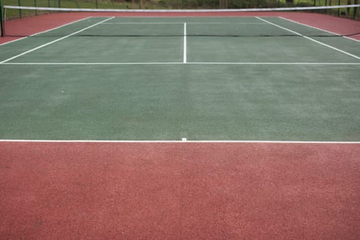 Empty tennis court available for the public, photographed in the evening