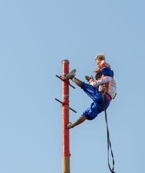 NAKHONSAWAN,THAILAND - FEBRUARY 13: Unidentified man and boy performance on a pole for Chinese New Year celebrations on February 13, 2013 in Nakornsawan, Thailand.