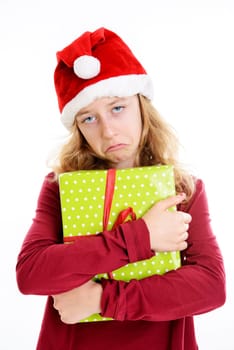 blond girl with Santa- cap is not happy with present