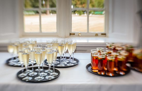 Glasses containing wedding punch and champagne to be served for guests