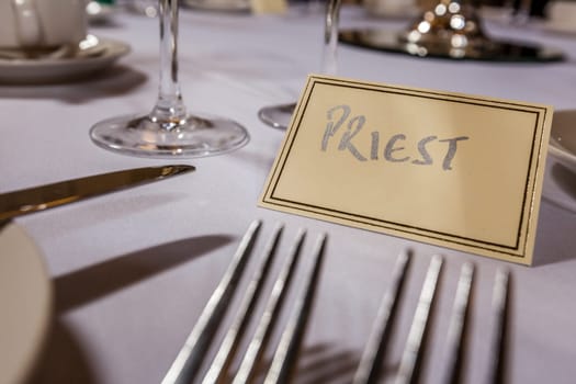 Priest seat at a table at wedding reception