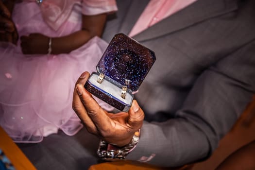 Groom showing the wedding rings during ceremony