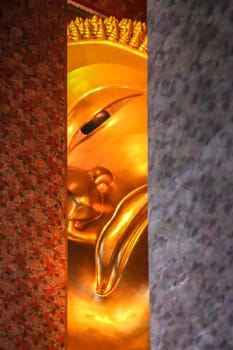 Head of the Reclining Buddha in a temple in Bangkok,  Thailand