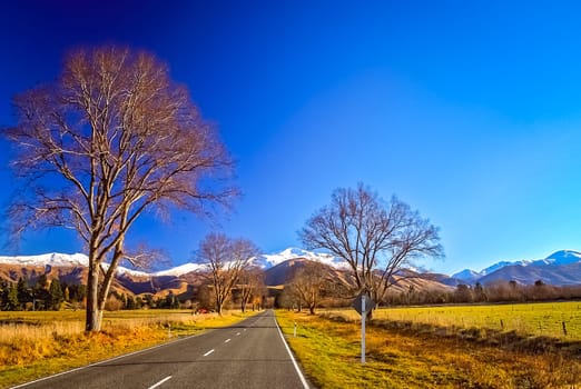 Road through the beautiful mountain scenery on the road to Mt Cook in New Zealand