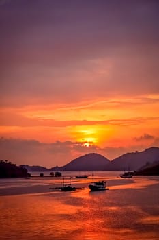 Sunset over bay in Labuhan Bajo town on the Flores island, Indonesia