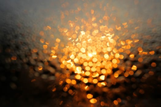 Diffused morning lights seen through wet window